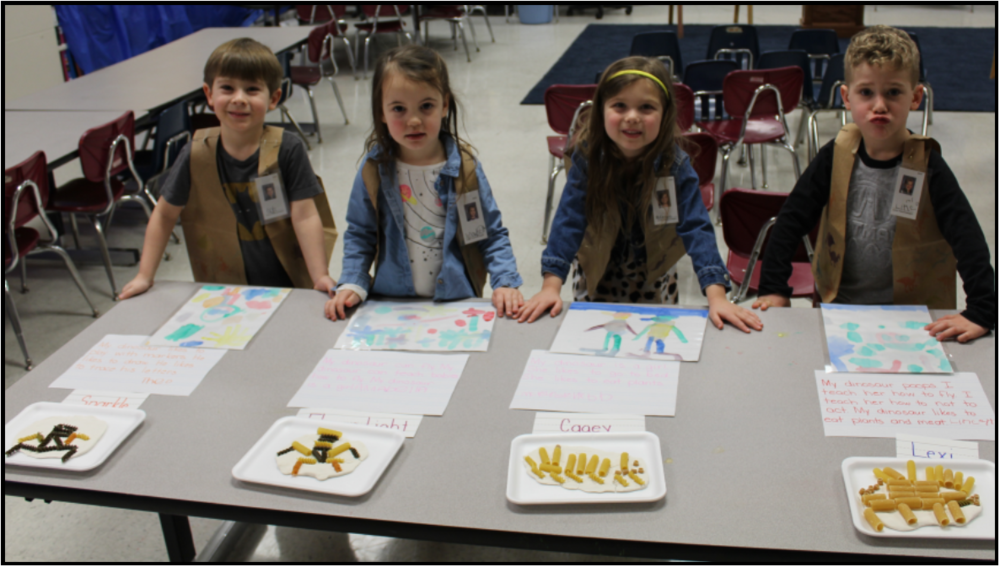 Preschool students presenting their findings on dinosaurs.